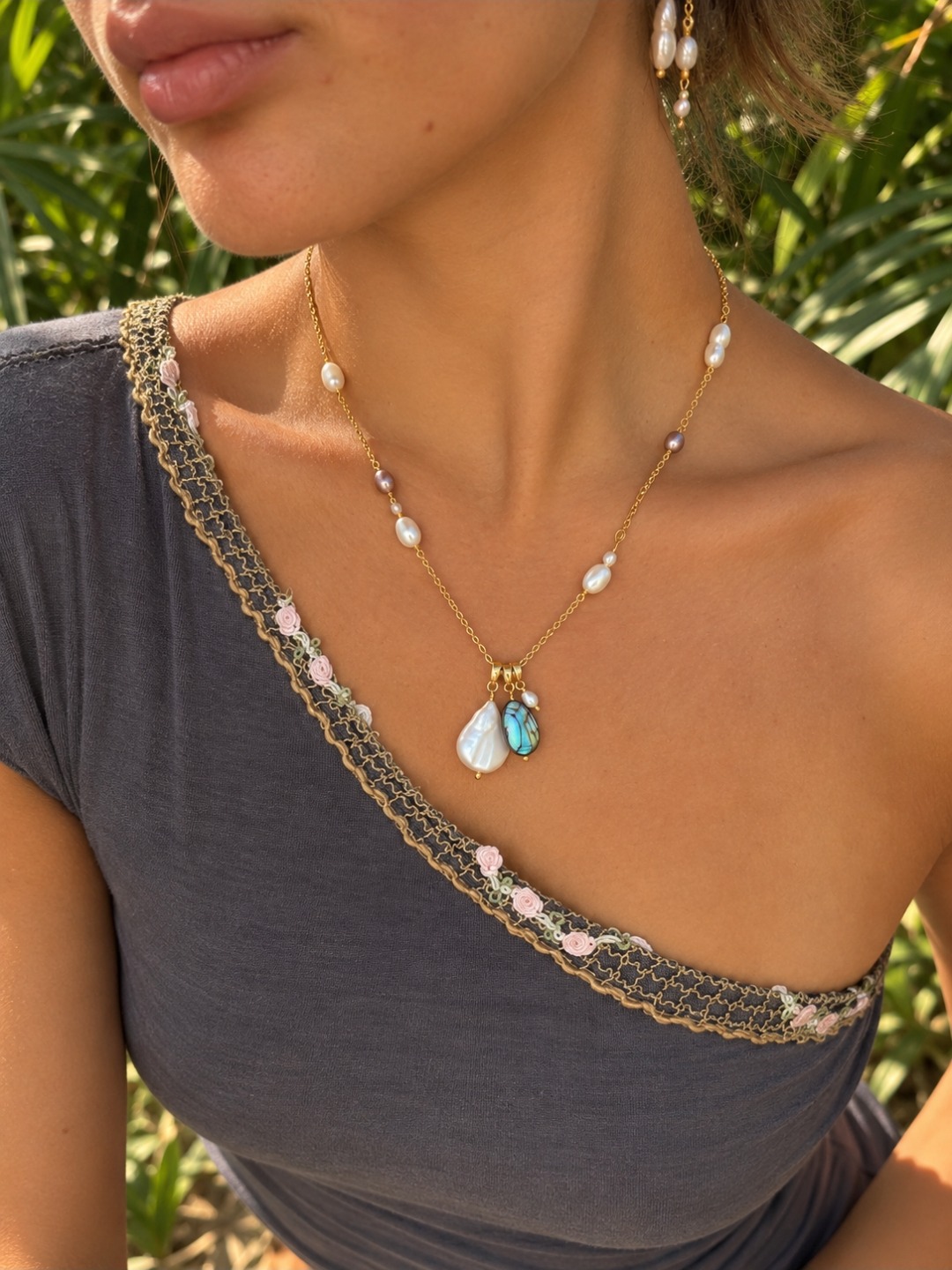 Finished custom necklace with pearl accents and white shell-like and blue-green pendant drops